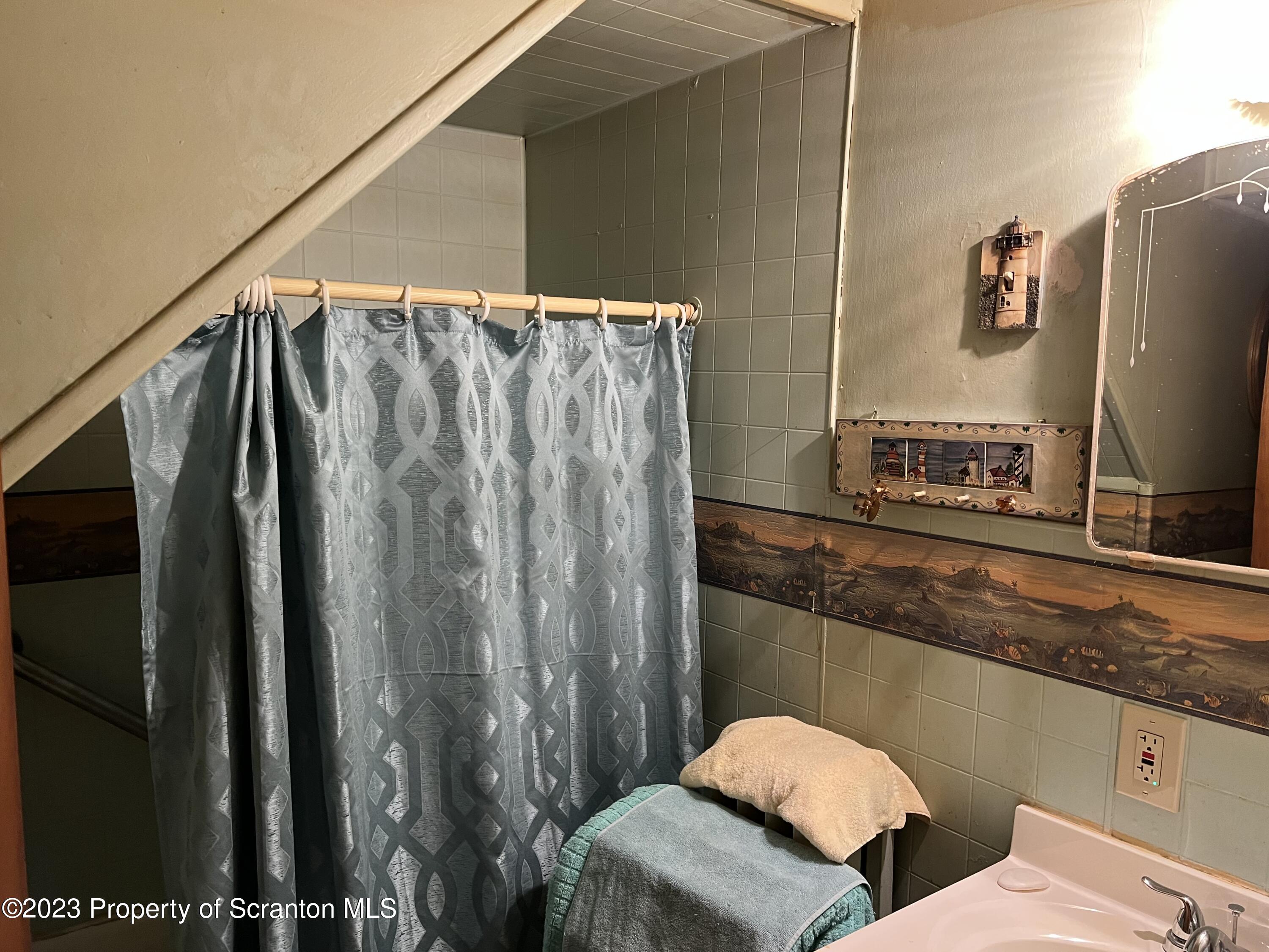 1613 Olive Street Scranton, PA 18510 - Photo 15 of 22 a bathroom with a granite countertop sink and a mirror