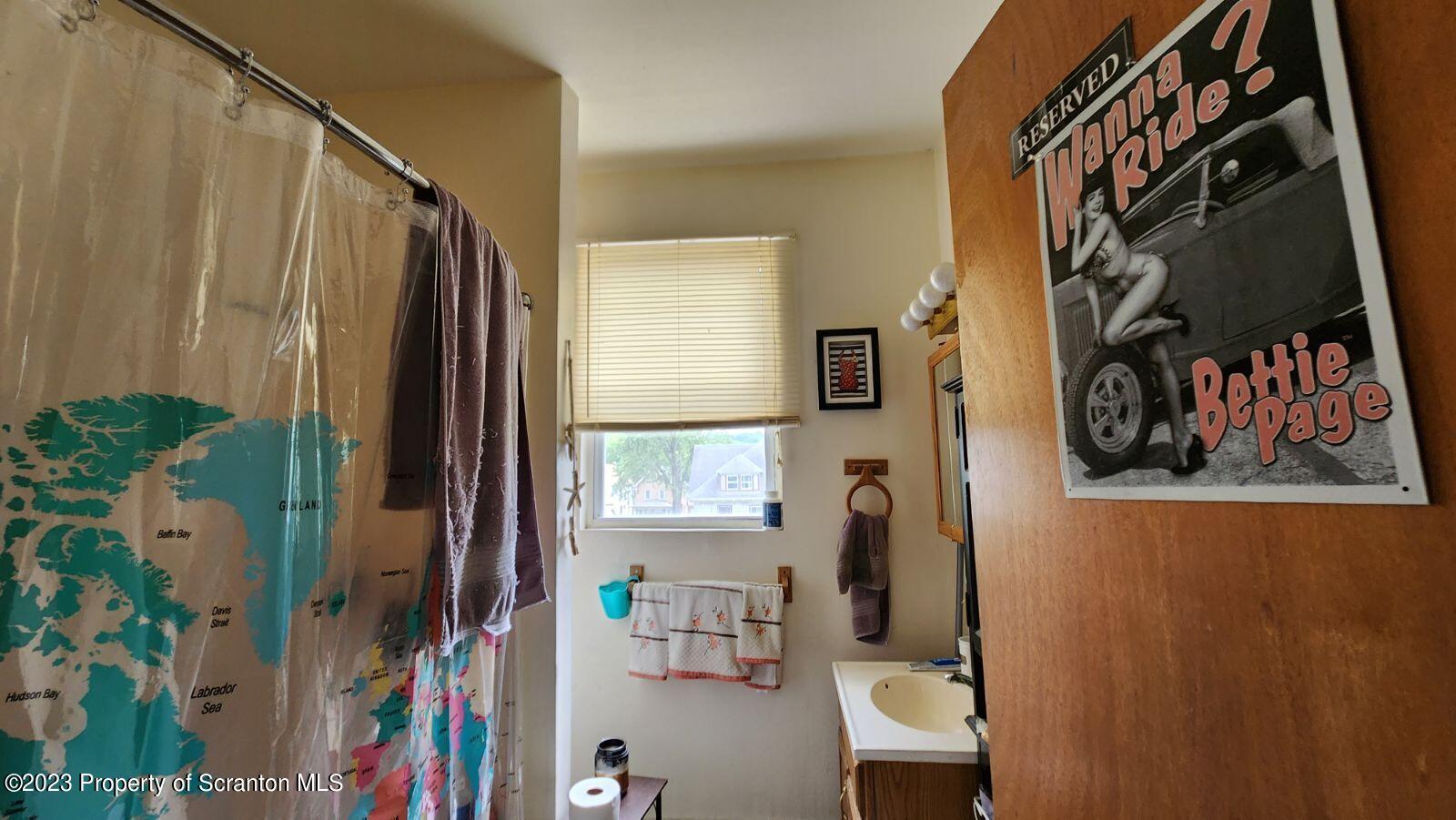 1613 Olive Street Scranton, PA 18510 - Photo 17 of 22 a bathroom with a bathtub and a shower curtain