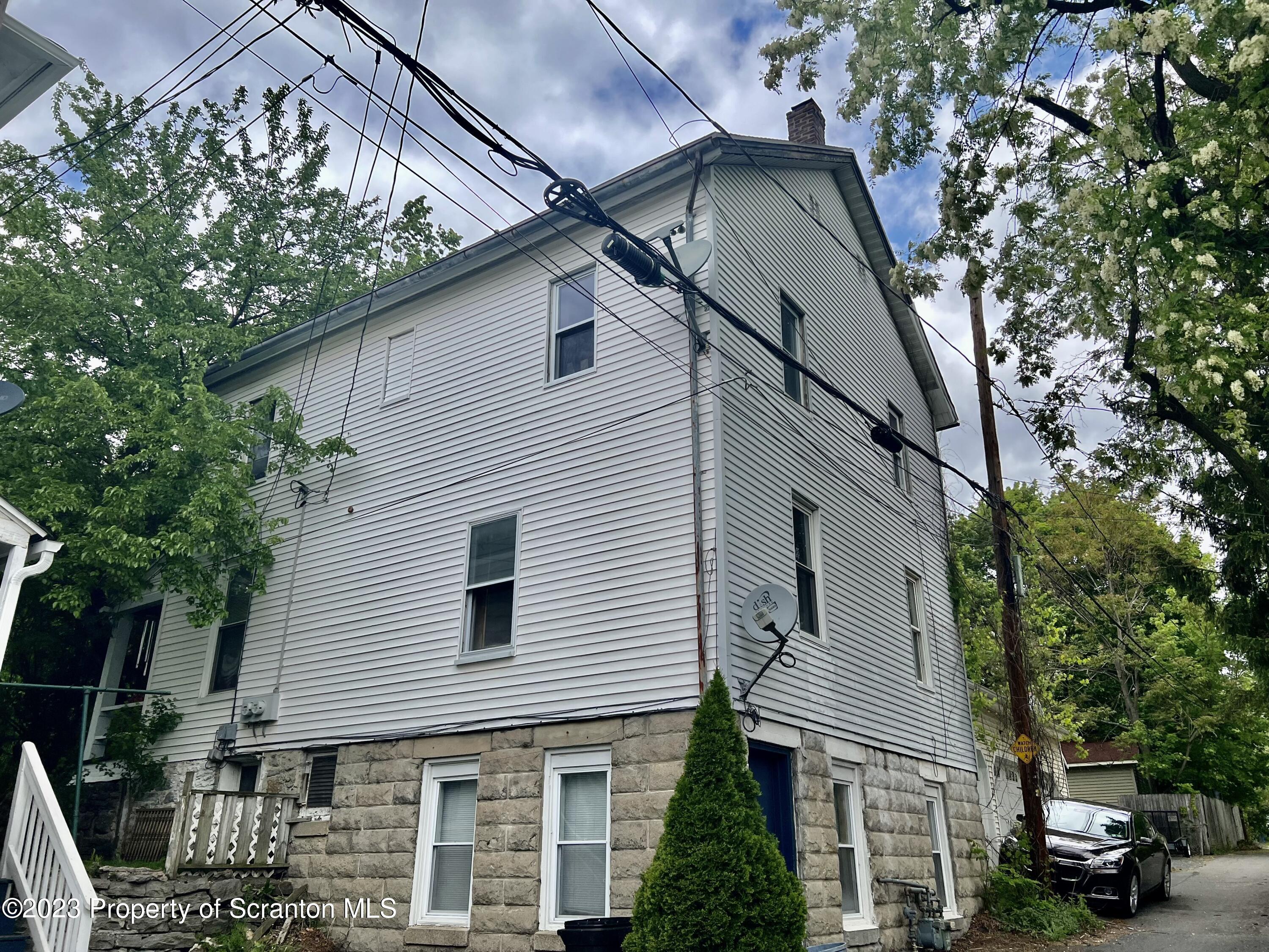 1613 Olive Street Scranton, PA 18510 - Photo 2 of 22 a view of a white house with large trees