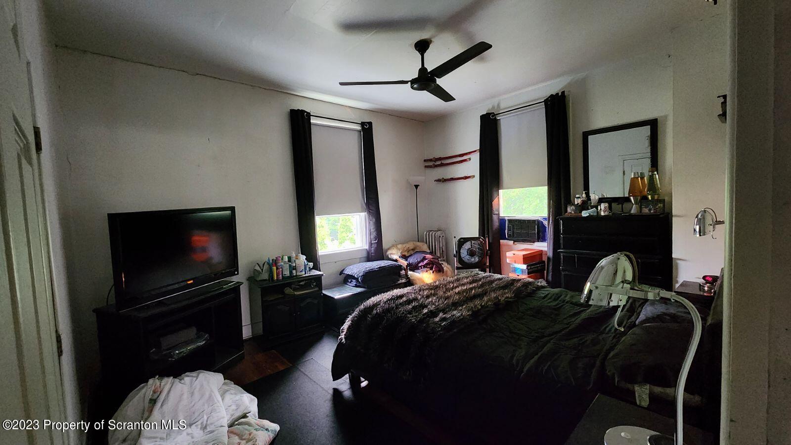 1613 Olive Street Scranton, PA 18510 - Photo 6 of 22 a bed room with a bed a television and a television