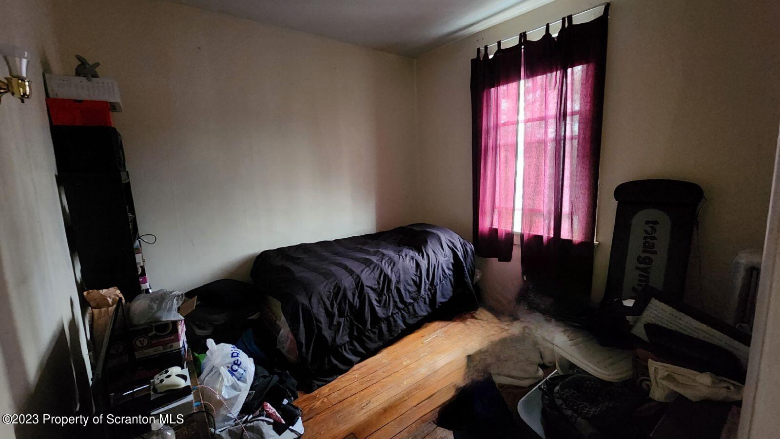 1613 Olive Street Scranton, PA 18510 - Photo 7 of 22 a bedroom with a bed and a window