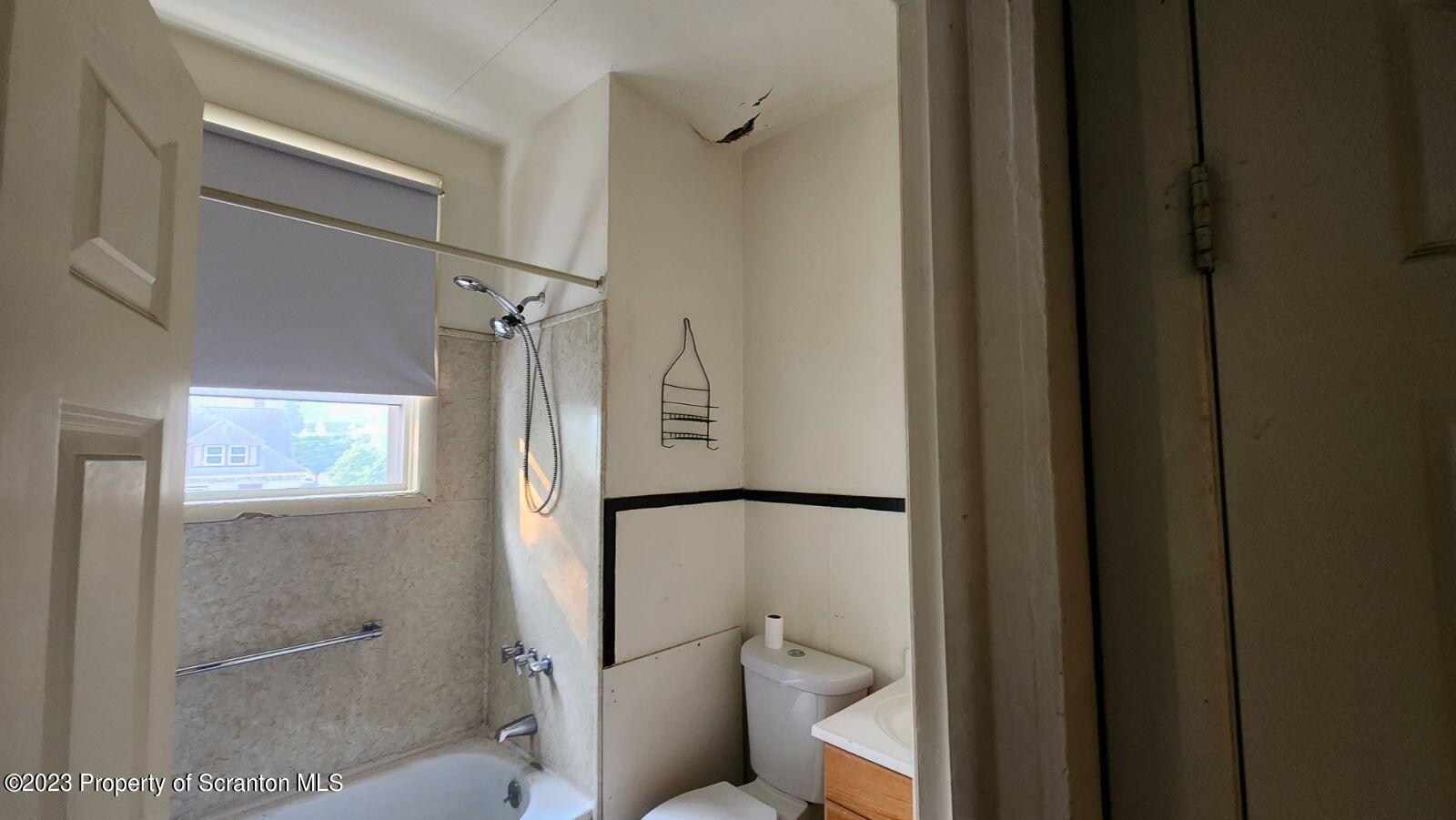 1613 Olive Street Scranton, PA 18510 - Photo 8 of 22 a bathroom with a toilet and a shower