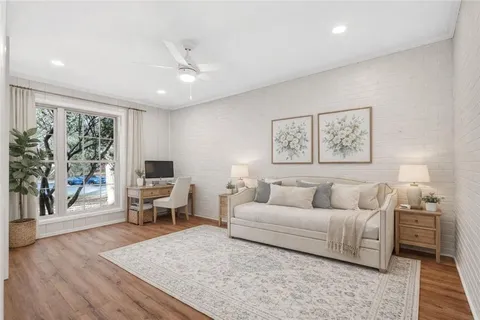 a living room with furniture and a wooden floor