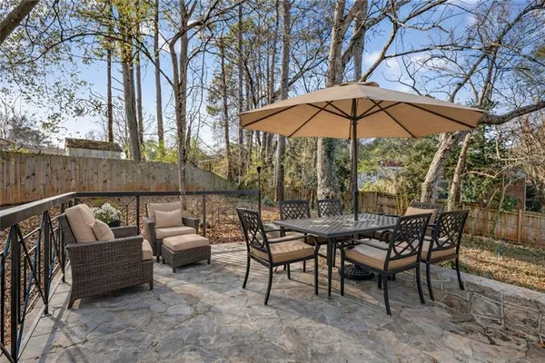 an outdoor sitting area with furniture and umbrella