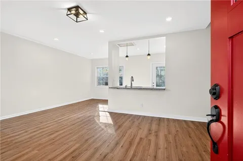 a view of empty room with wooden floor