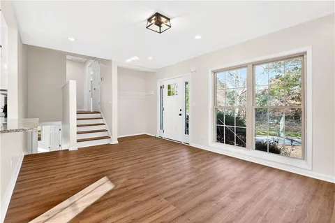 a view of a room with wooden floor and window