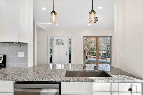 a view of lobby with granite countertop living room and couch