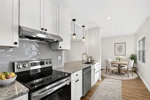 a kitchen with a stove and a cabinets