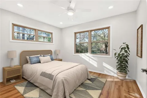 a bedroom with a large bed and a window