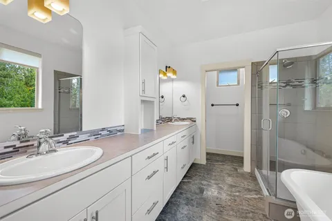a spacious bathroom with a granite countertop sink mirror and shower