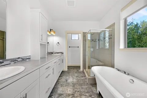 a bathroom with a tub sink and mirror