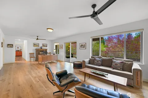 a living room with furniture a table and a large window
