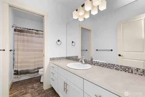 a bathroom with a sink a light fixture and a mirror
