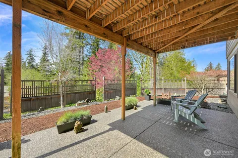 a roof deck with couch and chairs