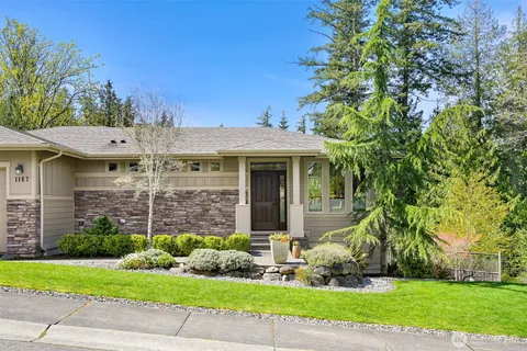a front view of a house with a garden