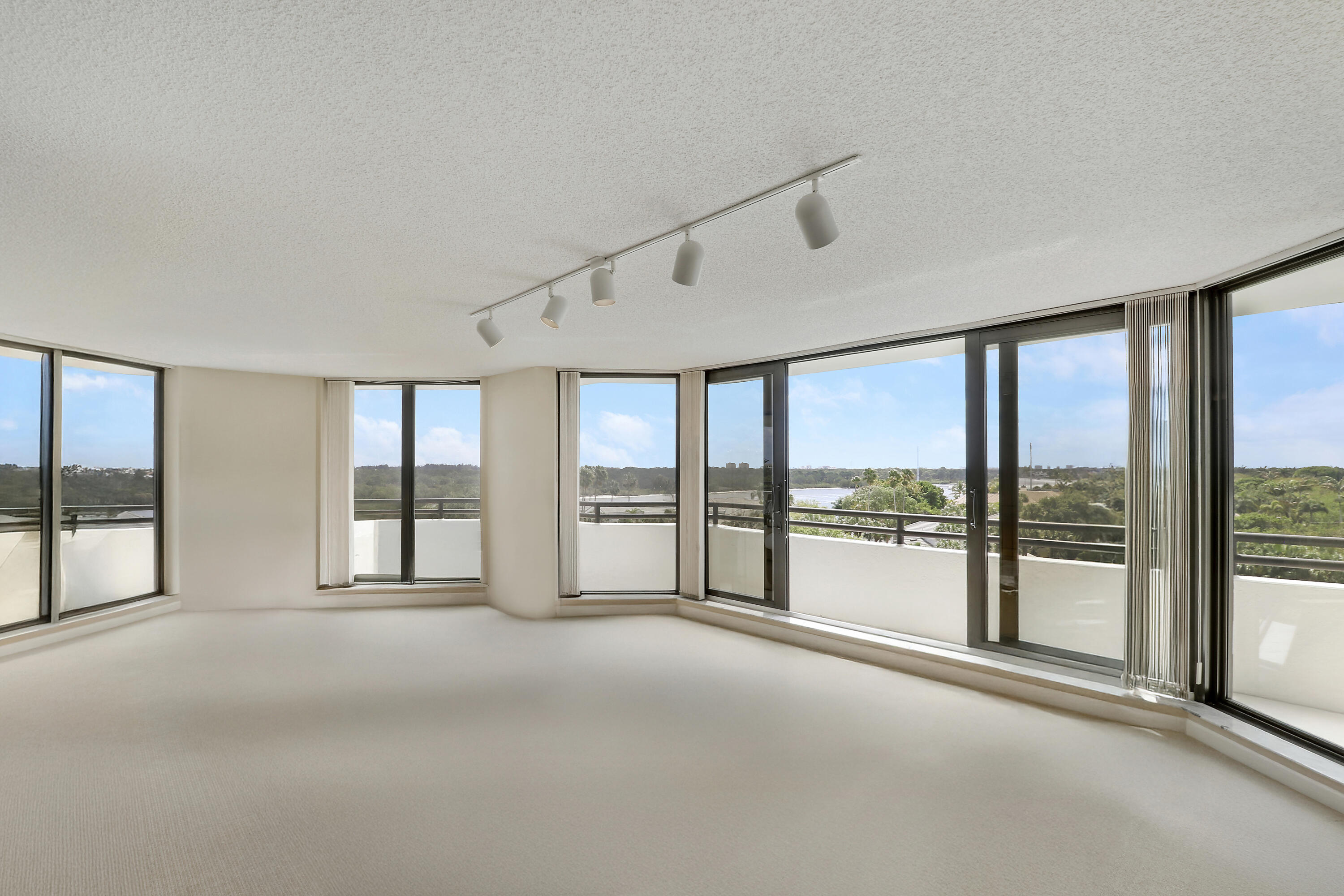3322 Casseekey Island Road, Unit 604 Jupiter, FL 33477 - Photo 12 of 55 a view of an empty room with windows and a balcony