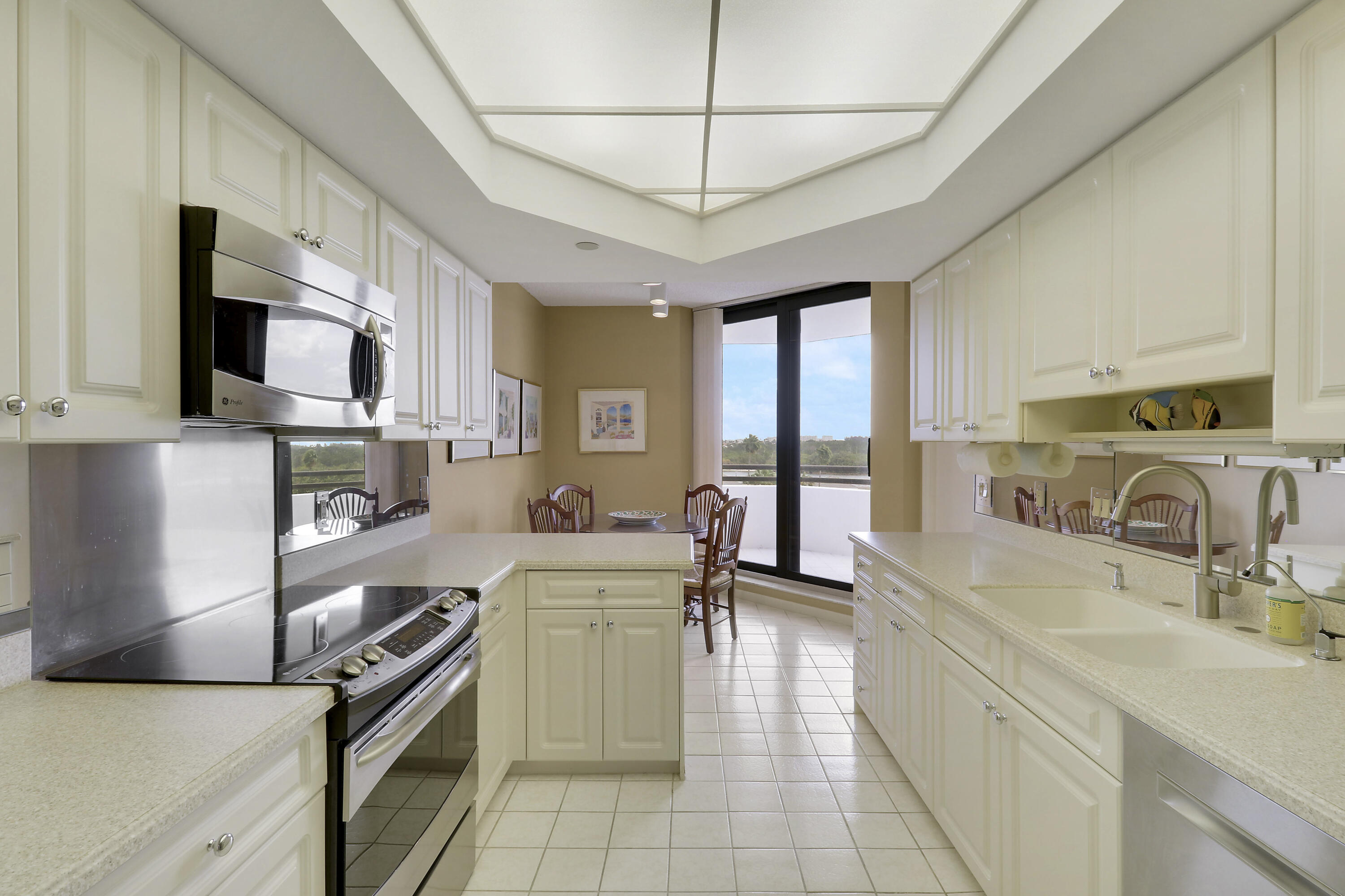 3322 Casseekey Island Road, Unit 604 Jupiter, FL 33477 - Photo 22 of 55 a kitchen with a sink appliances and cabinets