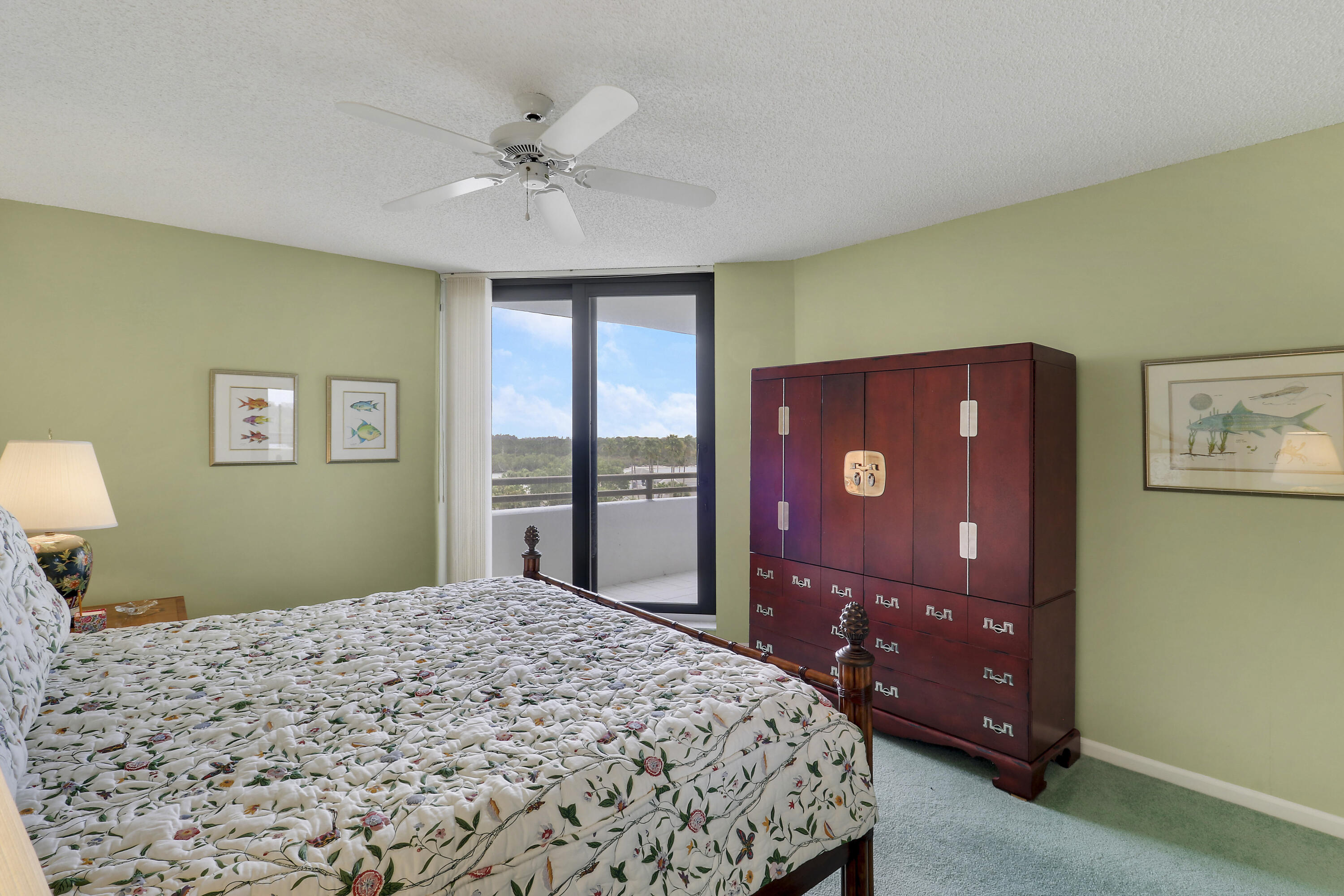 3322 Casseekey Island Road, Unit 604 Jupiter, FL 33477 - Photo 24 of 55 a bedroom with a bed and a dresser with mirror