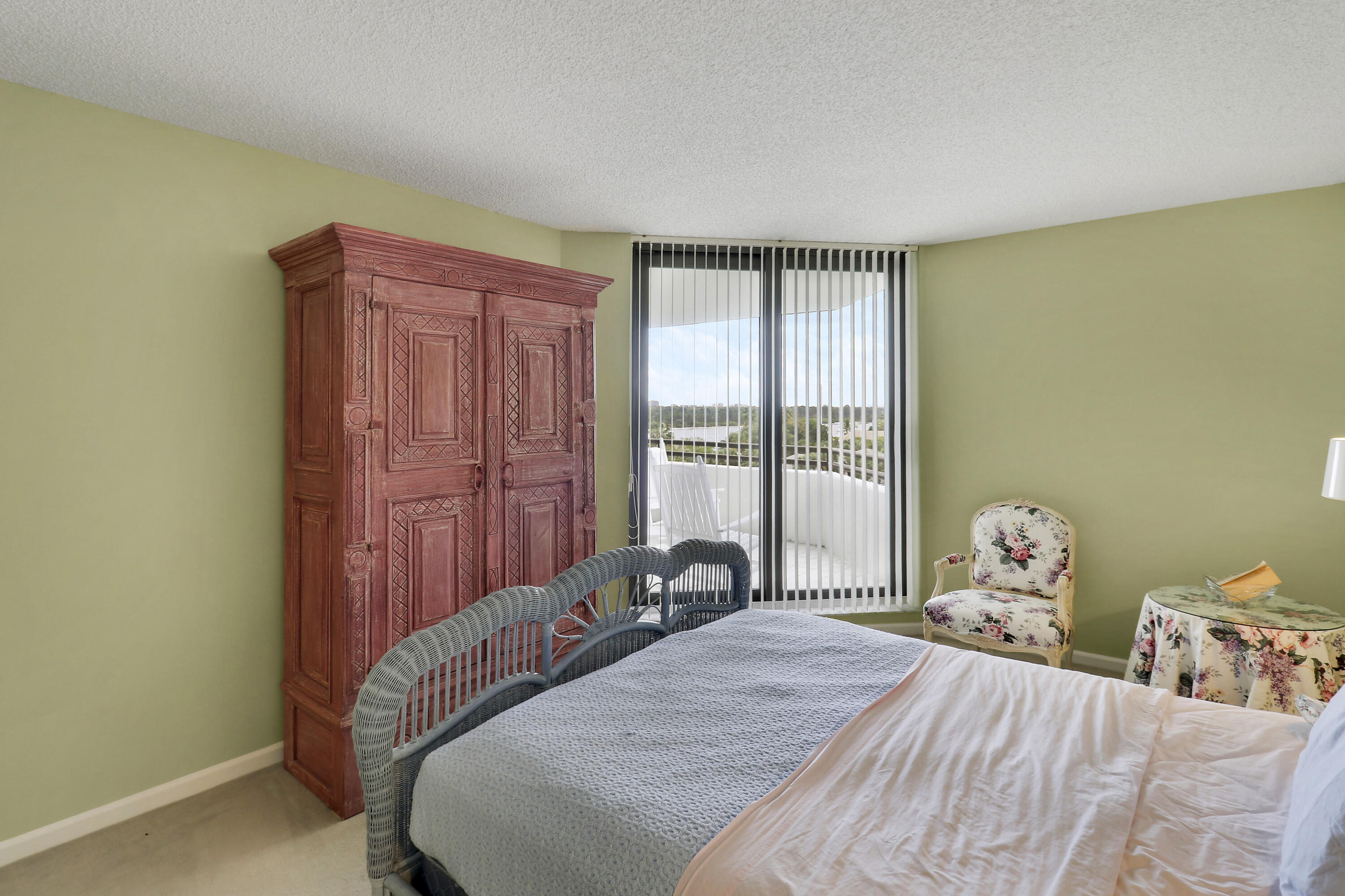 3322 Casseekey Island Road, Unit 604 Jupiter, FL 33477 - Photo 27 of 55 a bedroom with a bed and wooden floor