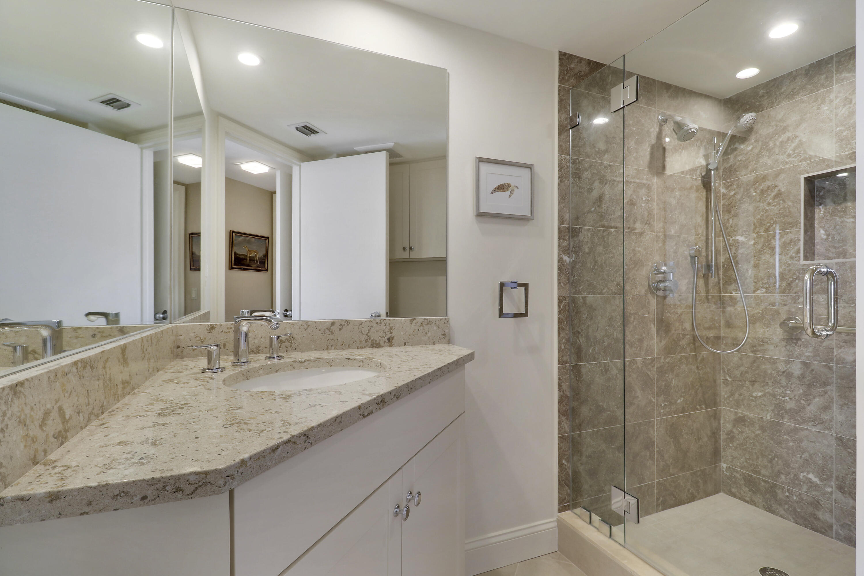 3322 Casseekey Island Road, Unit 604 Jupiter, FL 33477 - Photo 33 of 55 a bathroom with a granite countertop sink a toilet a shower and a mirror