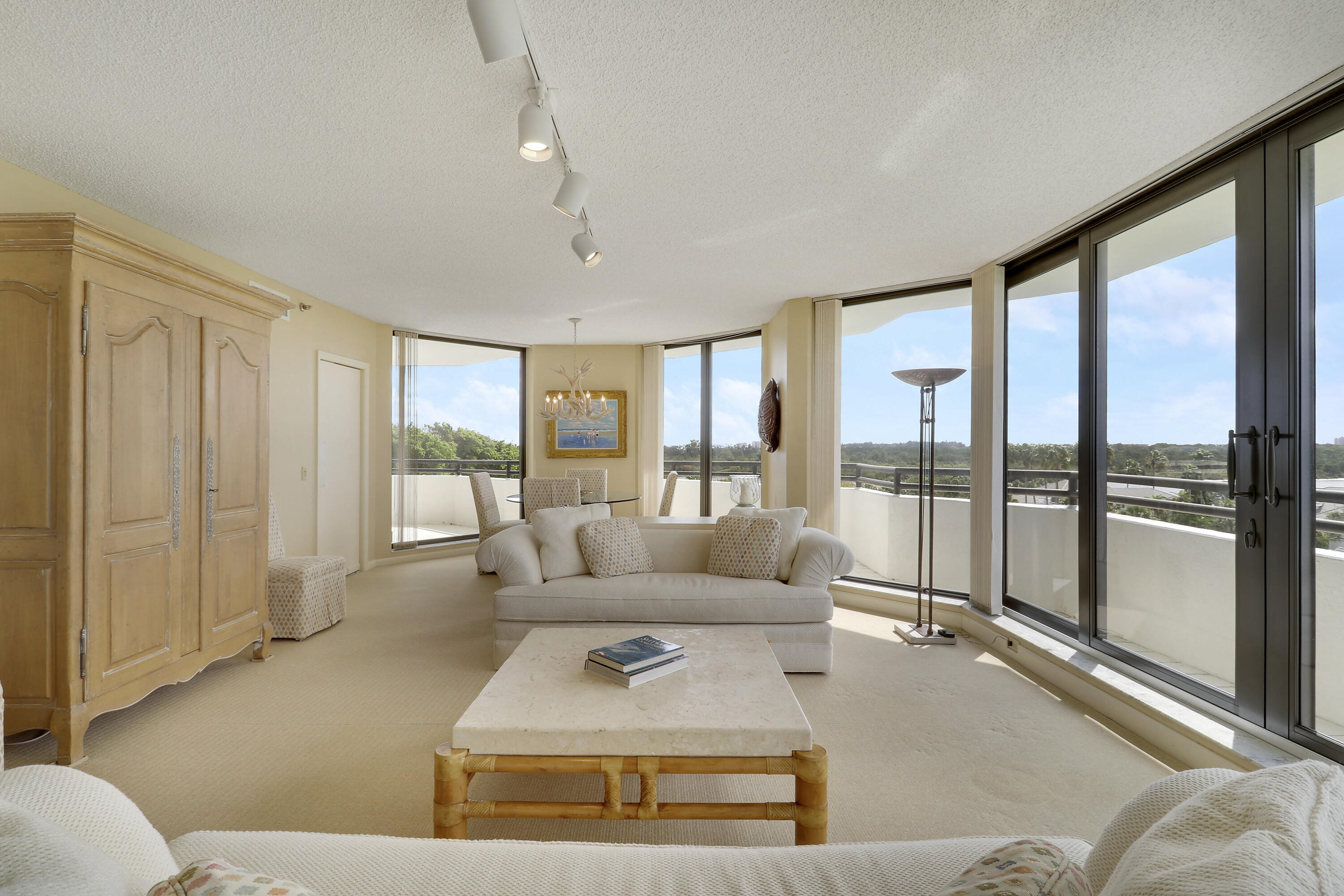 3322 Casseekey Island Road, Unit 604 Jupiter, FL 33477 - Photo 10 of 55 a living room with furniture and a large window with balcony view
