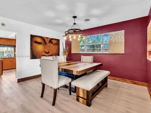 a view of a patio with a table and chairs under an umbrella