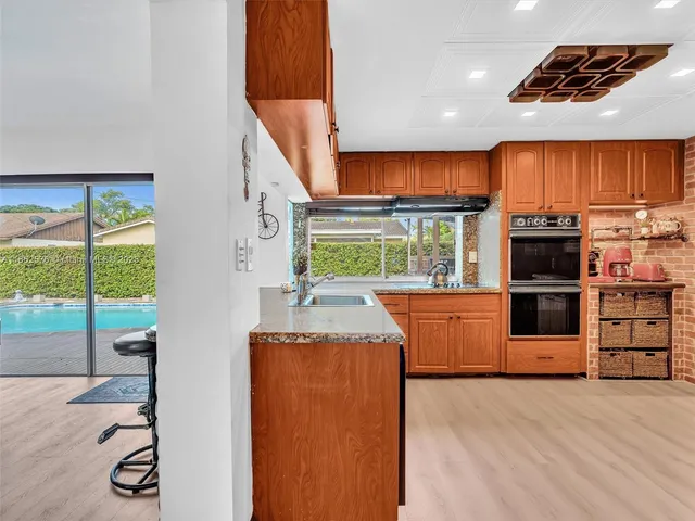 a bedroom with a large bed and a painting on the wall