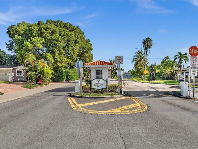 a front view of a house with a yard and a garage