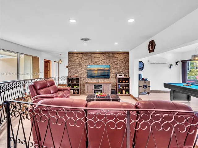 a kitchen with stainless steel appliances granite countertop a refrigerator a sink dishwasher and wooden cabinets with wooden floor