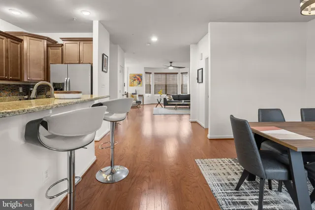 a view of a dry yard with trees in the background