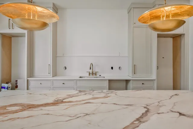 a bathroom with a sink a large mirror and a shower