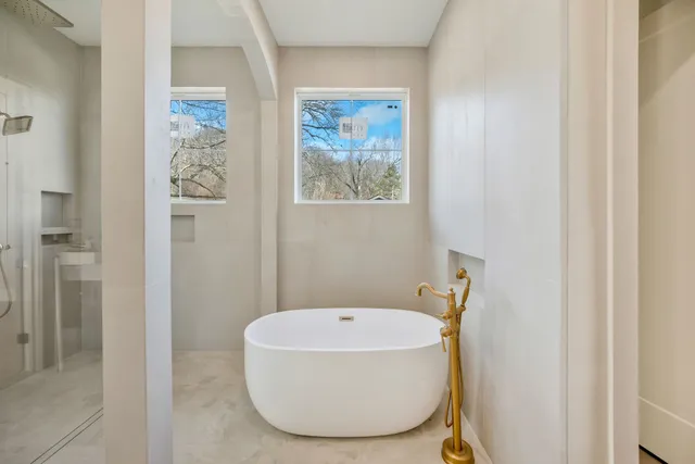 a bathroom with a tub and shower