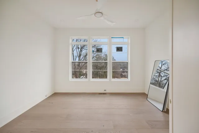 a bathroom with a granite countertop sink toilet mirror and shower