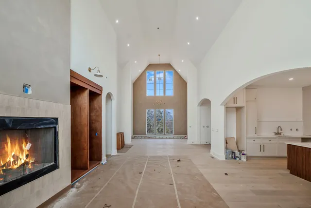 a large kitchen with granite countertop a sink and dishwasher a refrigerator with wooden cabinets