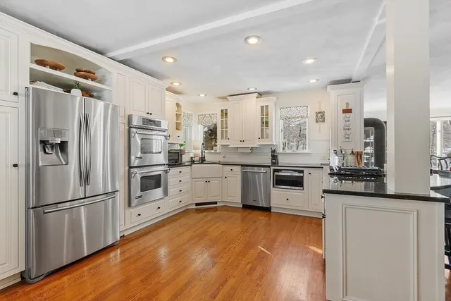 a kitchen with stainless steel appliances a refrigerator sink and microwave