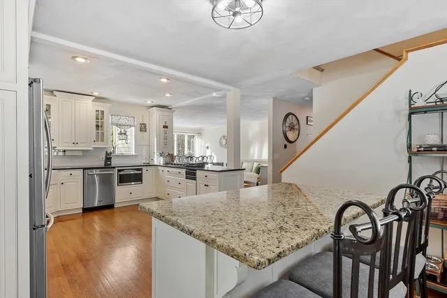 a living room with stainless steel appliances kitchen island granite countertop furniture and a kitchen view
