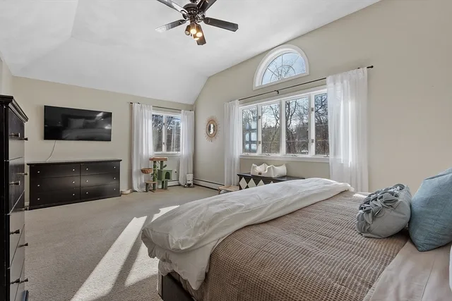 a bedroom with a bed and a large window