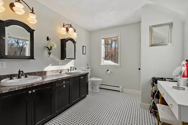 a bathroom with a double vanity sink mirror and