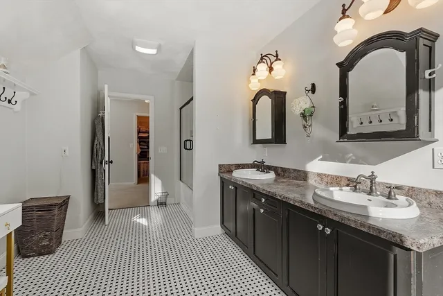 a bathroom with a double vanity sink and a mirror