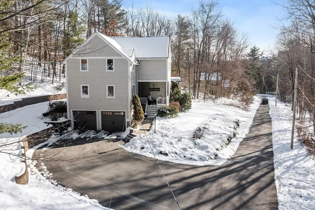 a view of a house with snow on the road