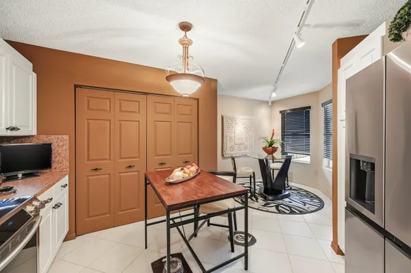 a view of a kitchen area with furniture and wooden floor