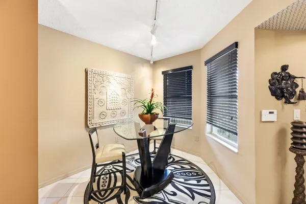 a view of a dining room with furniture and window