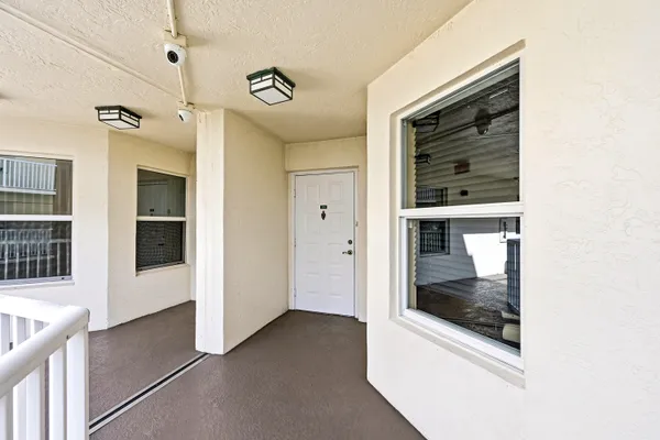 a view of a hallway with a glass door and a window
