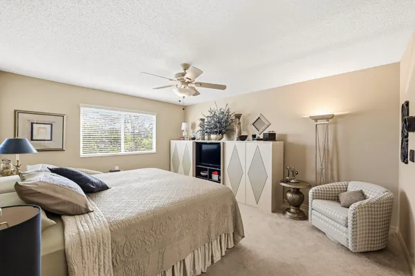 a bedroom with a bed a couch and dresser