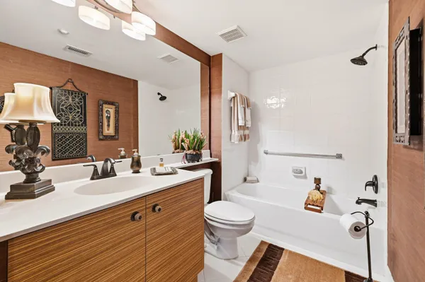 a bathroom with a sink mirror vanity and toilet