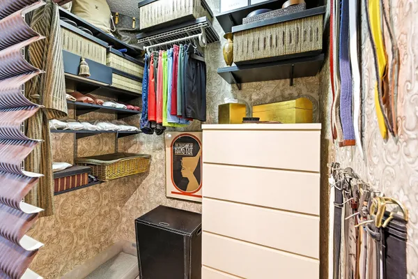 a view of walk in closet with clothes and shoes