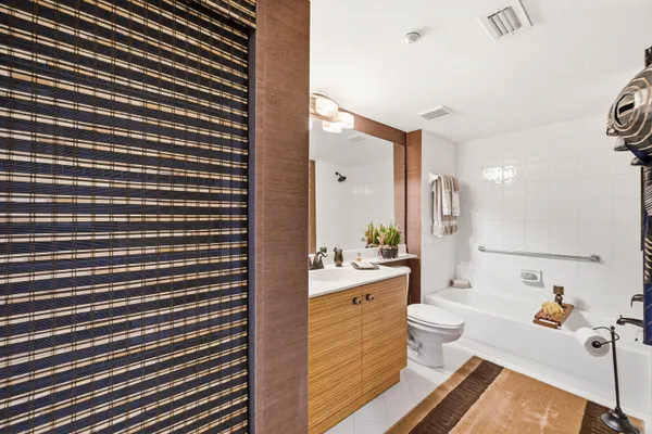 a bathroom with a sink mirror vanity and toilet