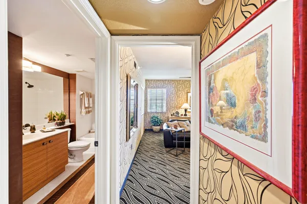 a hall with wooden floor and furniture