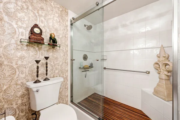 a bathroom with a sink toilet and shower