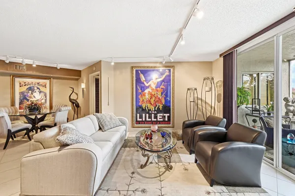a living room with furniture ceiling fan and a rug